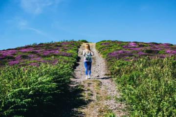 blonde woman walking on trail outdoors