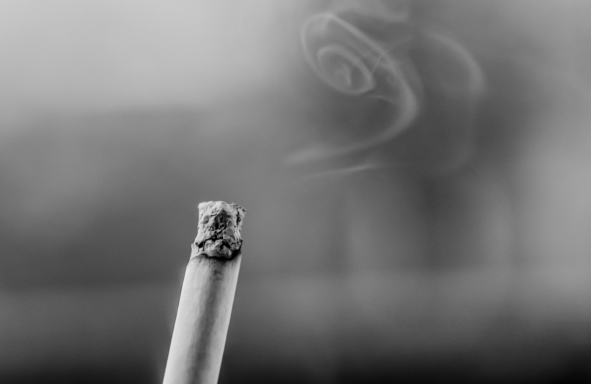 black and white image of lit cigarette