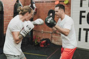 two men fighting mma with boxing gloves